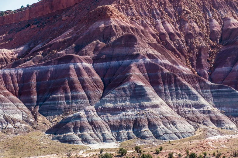 mountains are painted red, green and blue and have a mountain range