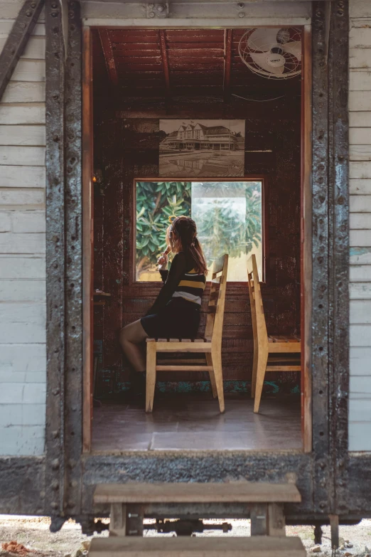 there is a woman that is sitting on a chair in the doorway