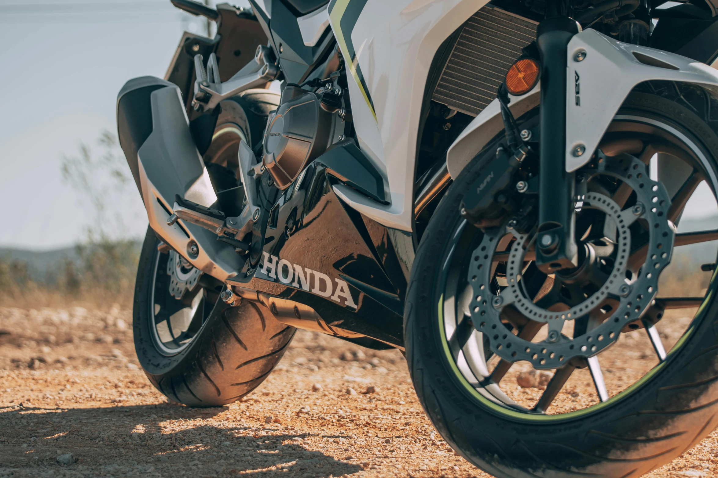 a parked motorcycle is in the middle of an open field