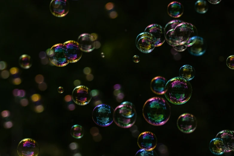 many bubbles hanging from a dark sky above