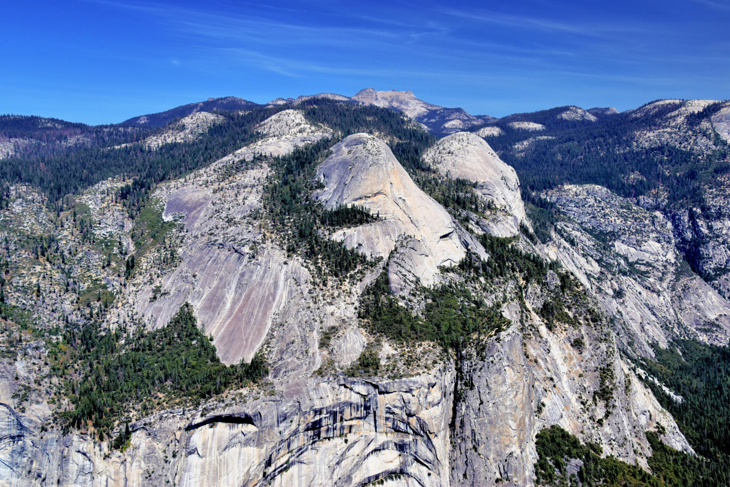 a mountain with a steep cliff and trees