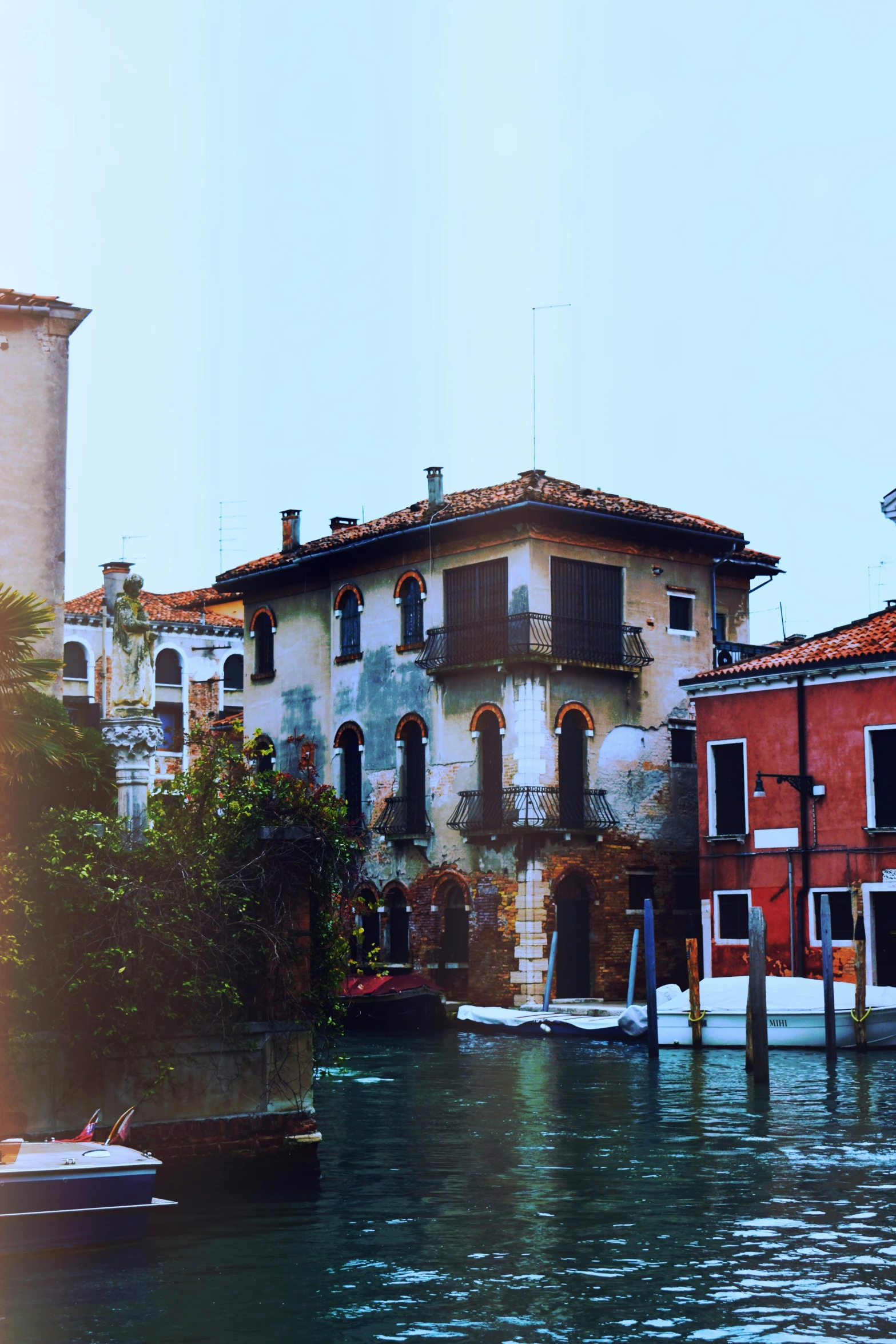 an image of a boat going down the canal by buildings