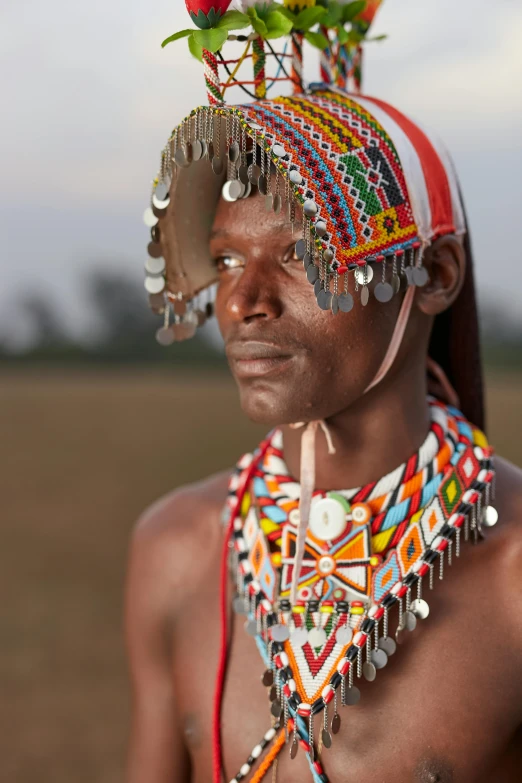 a person wearing a beaded necklace and headgear