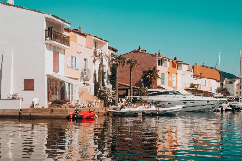 a row of houses near the water with a white boat on the dock