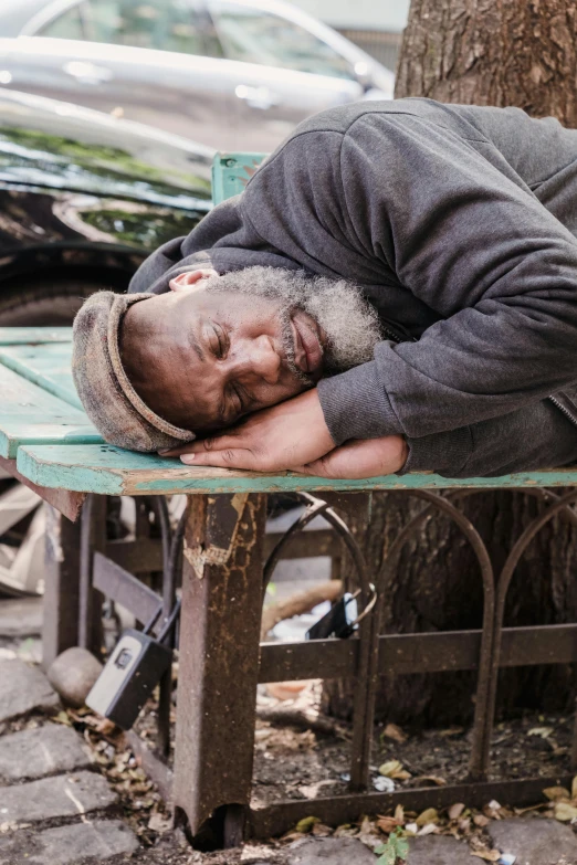 a man that is sleeping on a bench