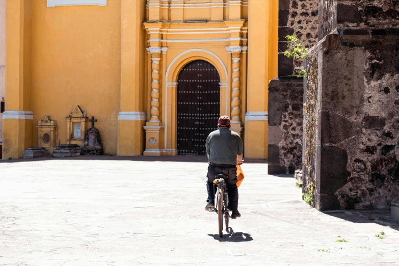 the man is riding his bike down the road