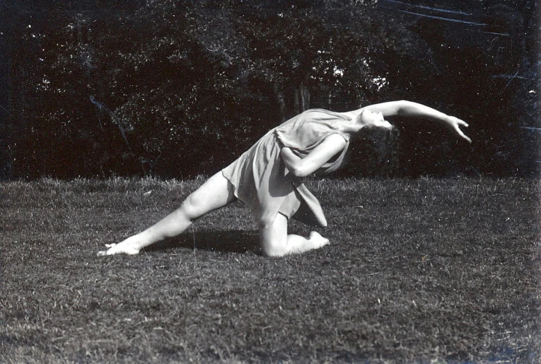 a woman laying in the grass on her stomach