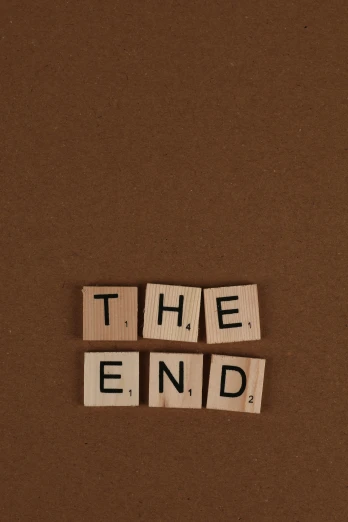 a close up s of the word the end spelled by scrabble type letters