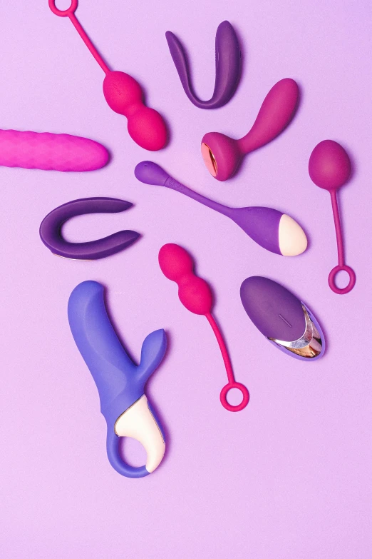 different colored toothbrushes on a purple background