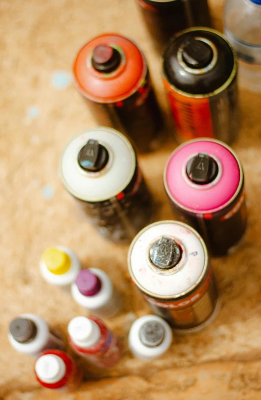 many different colors and sizes of cans are on the ground