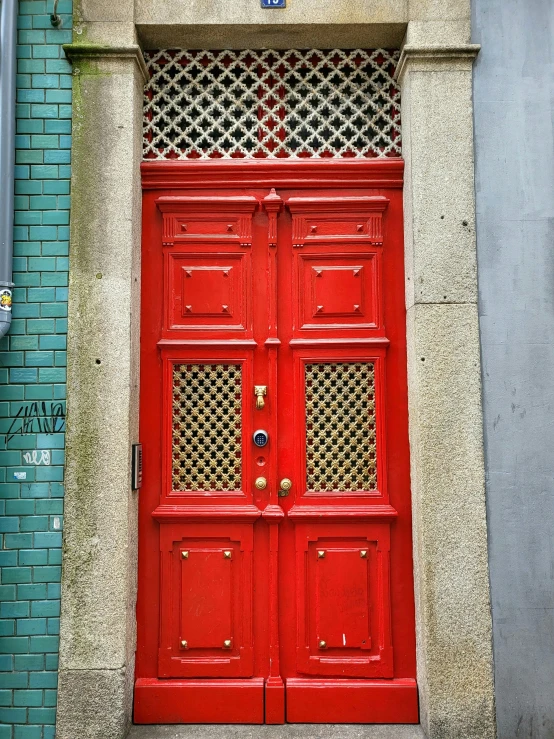 two red doors are on the side of an apartment building