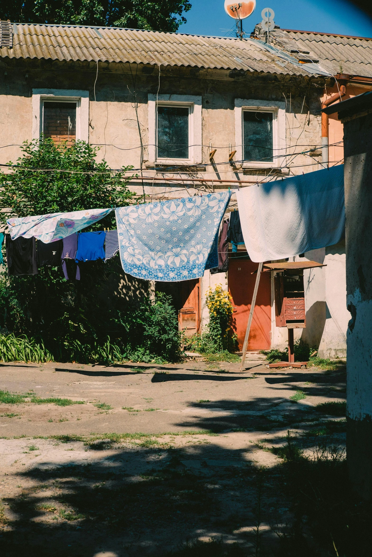 a clothes line in front of an abandoned building