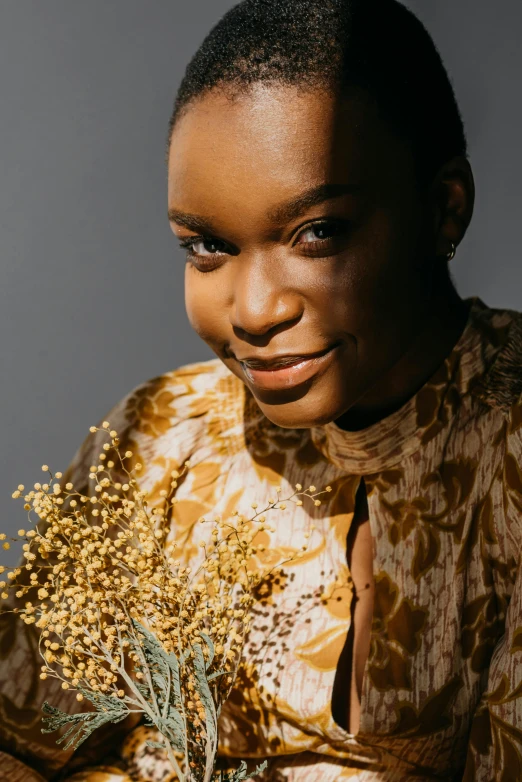 the woman is wearing an animal print blouse with an earring