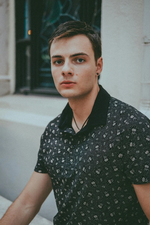 a man sitting in front of a building