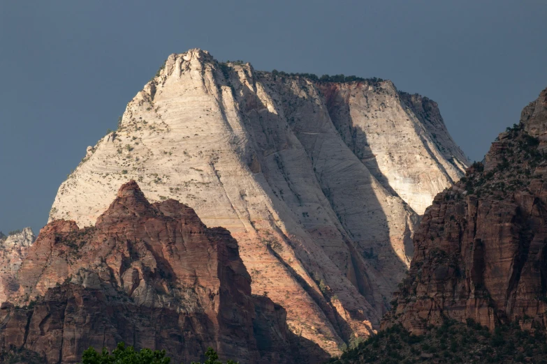 a mountain peak with trees around it