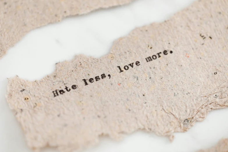 a torn piece of paper with writing that says we need, love more