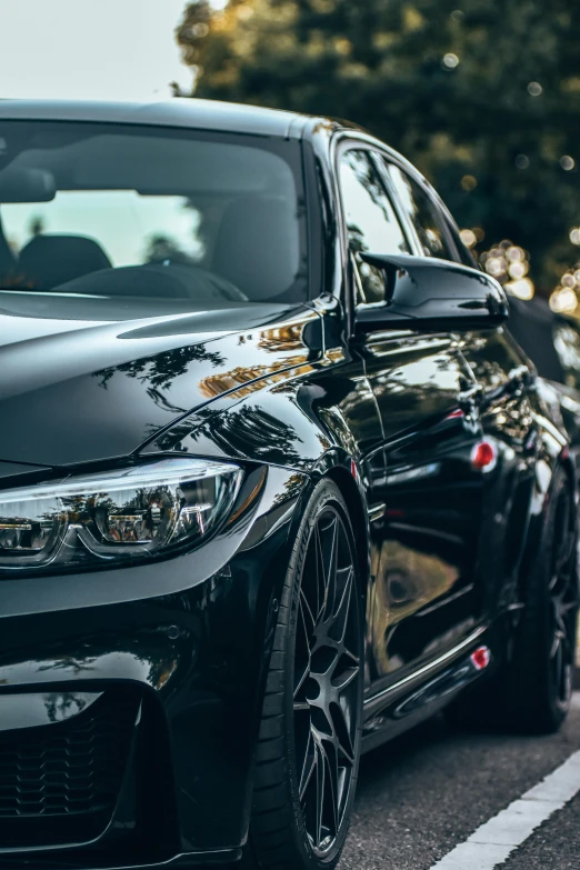 black bmw parked in the middle of the road