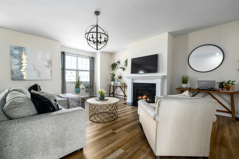 a white living room with a fireplace and a mirror