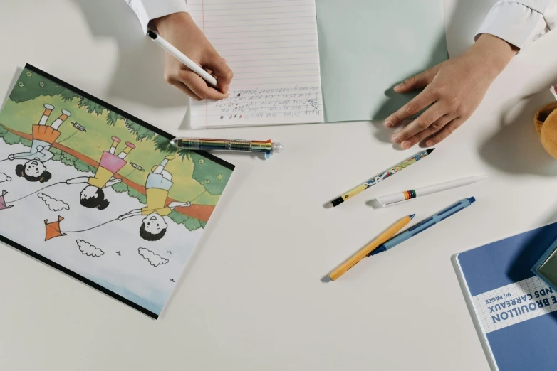 a person is doing crafts on the desk