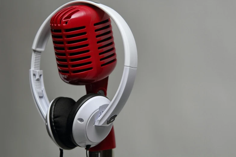 an electric red microphone hooked to headphones