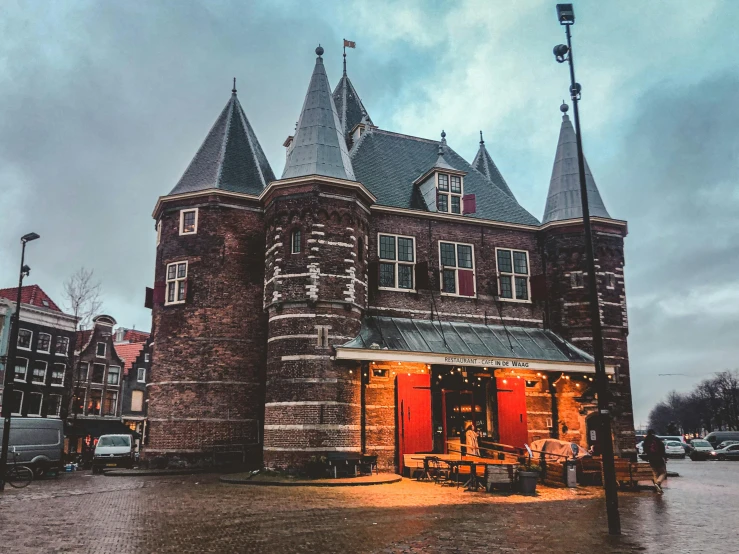 an old building on the corner in front of cars