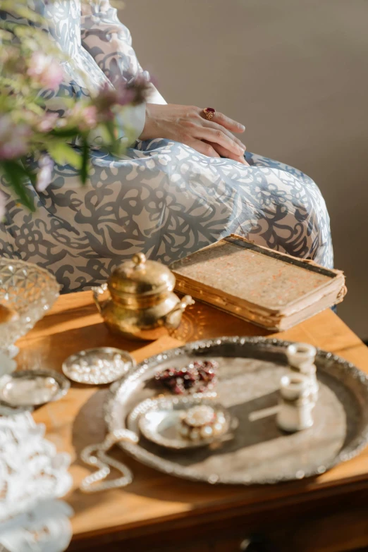 an antique tray is shown next to dishes