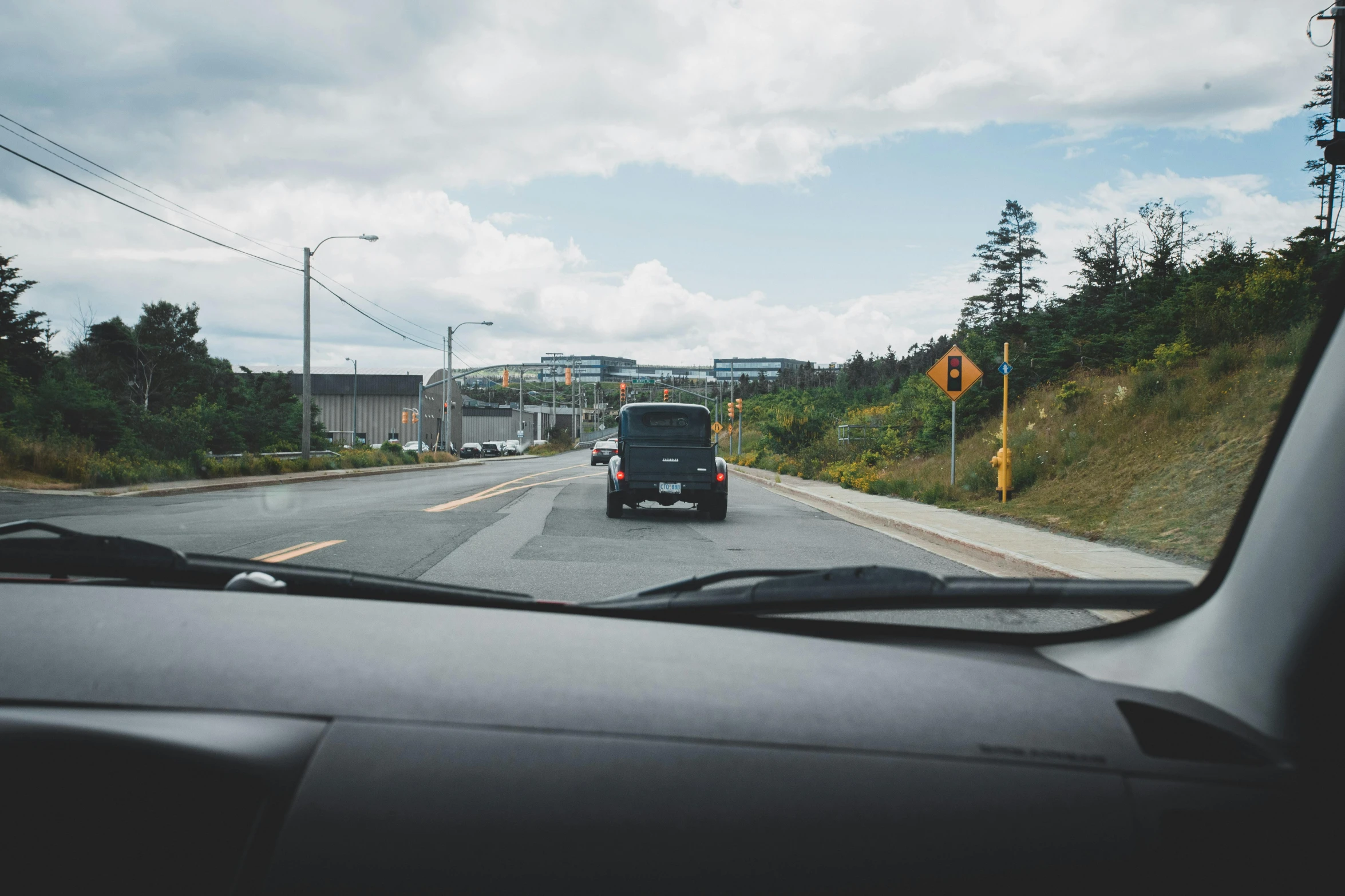 the truck is approaching the crossing sign by the road