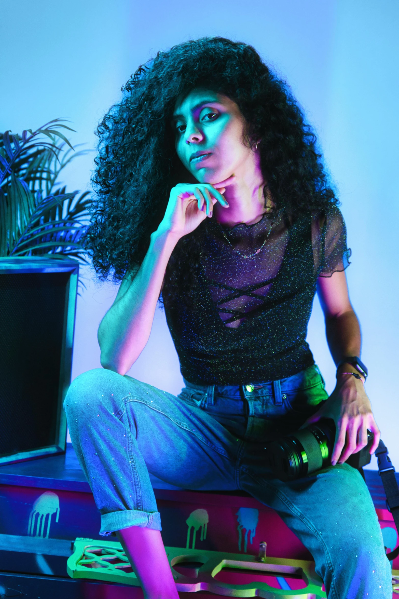 a young woman poses in the color of neon light
