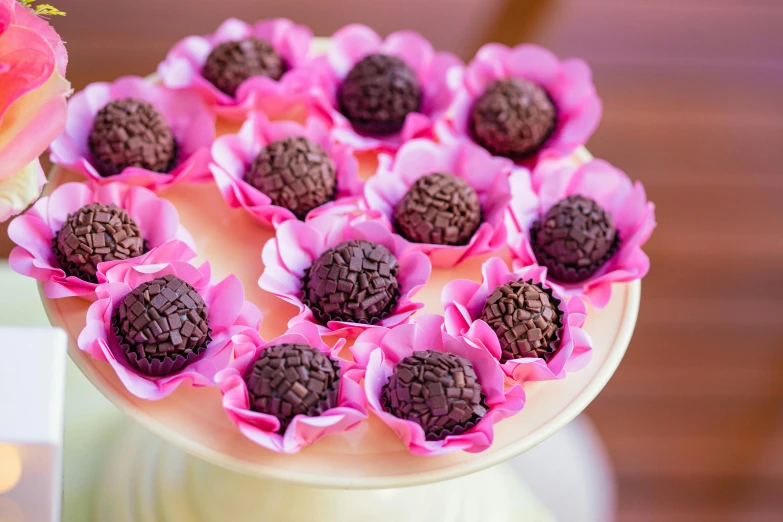 a vase of flowers with dark cake inside it