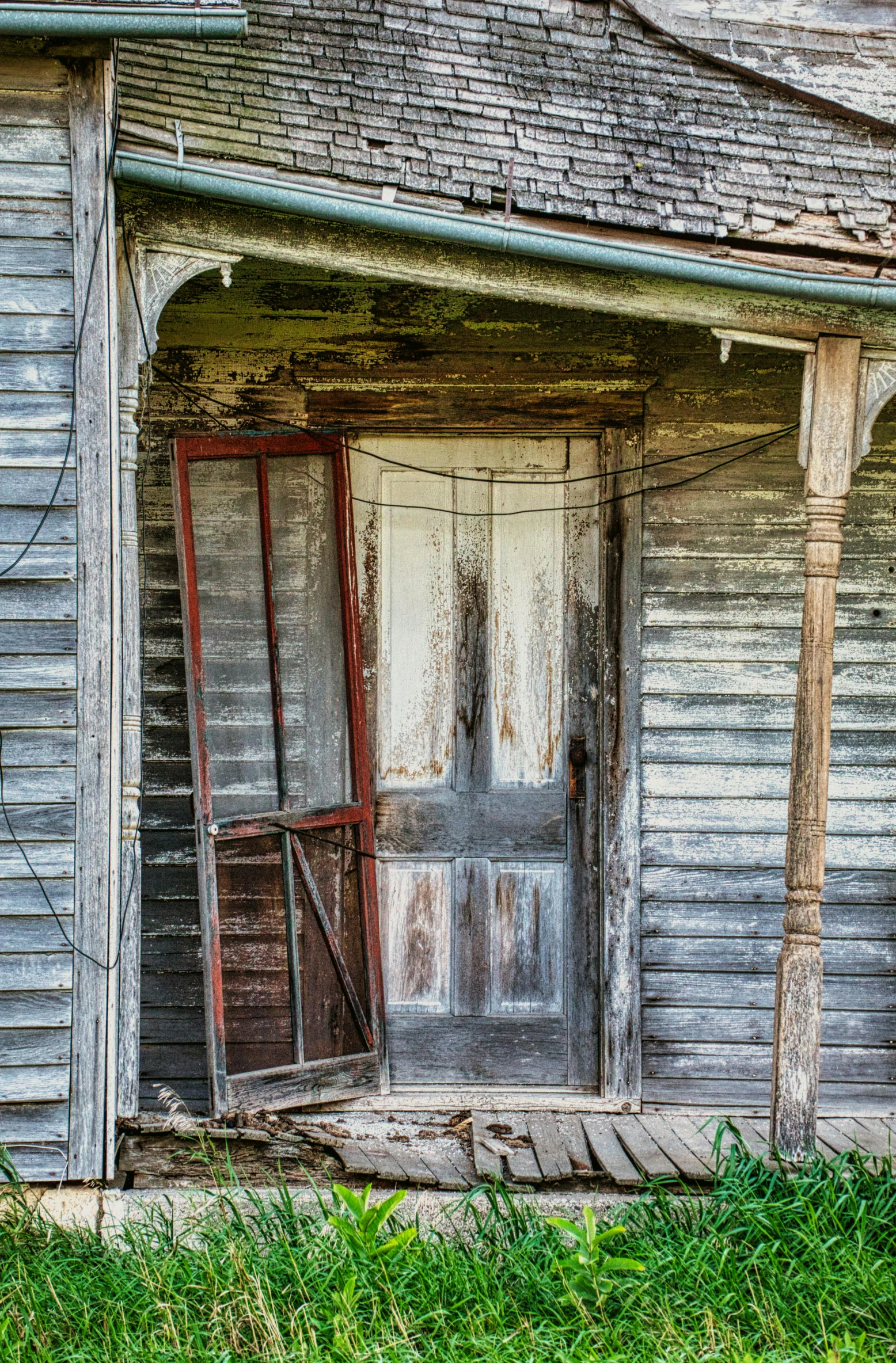 an old, run down building with a broken door