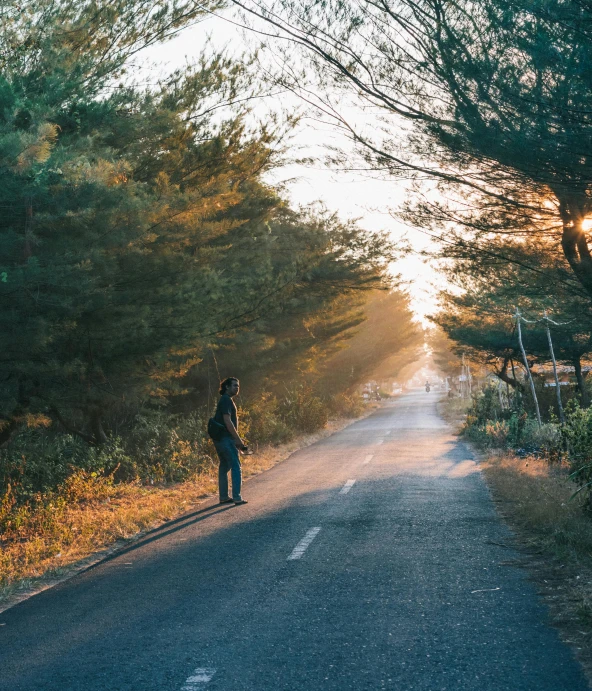 a person standing on the side of a road