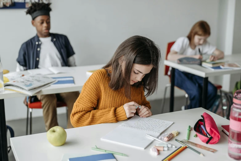 a little girl working on her notebook in the class room