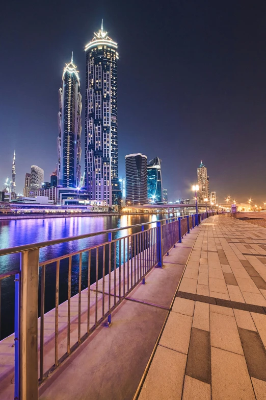 the city skyline has tall buildings beside a river