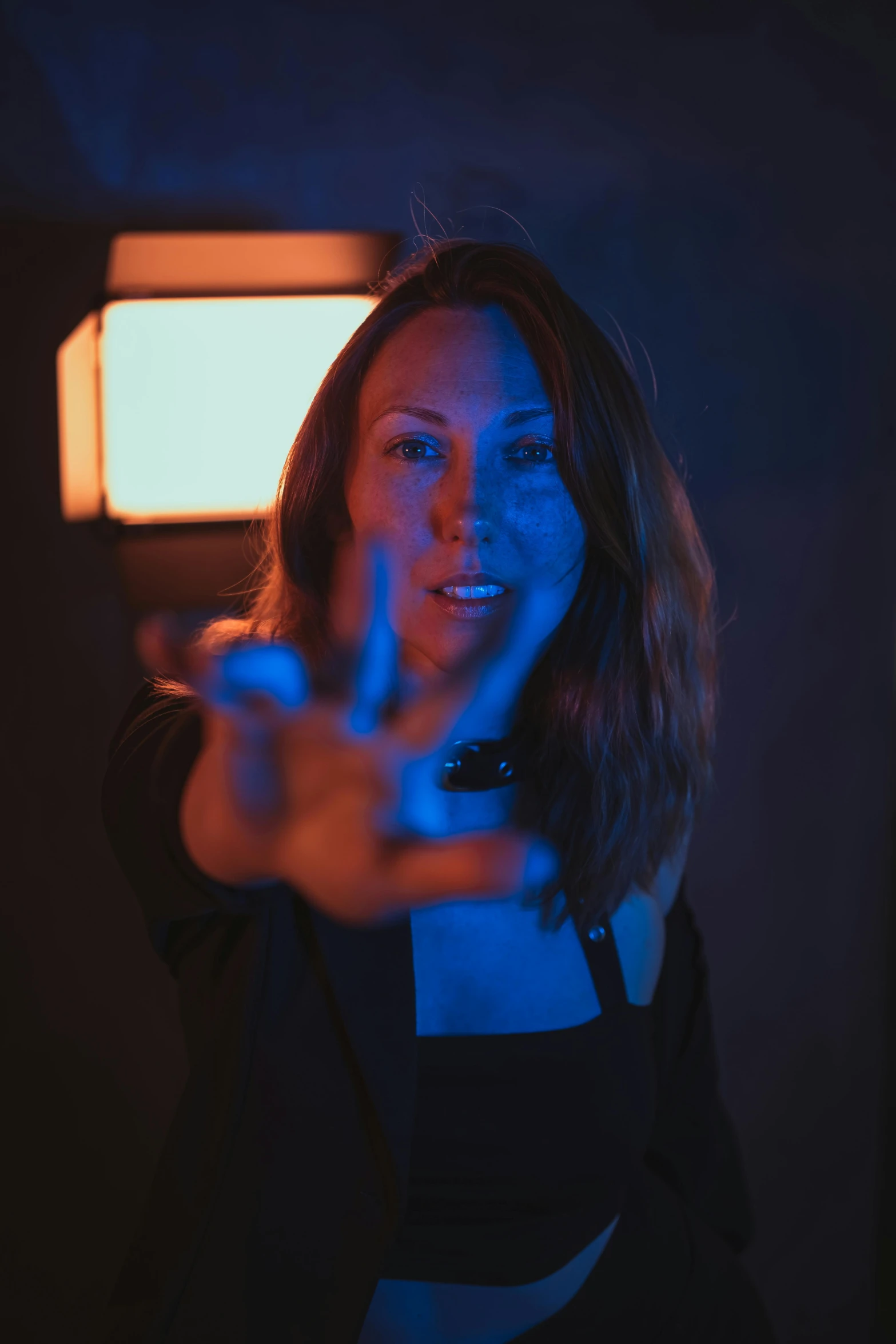 a woman pointing at soing on the screen