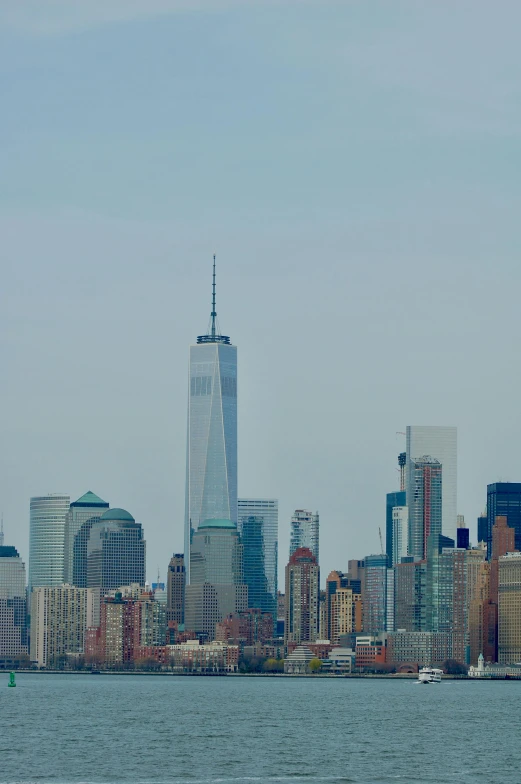 there is a boat going past the tall building