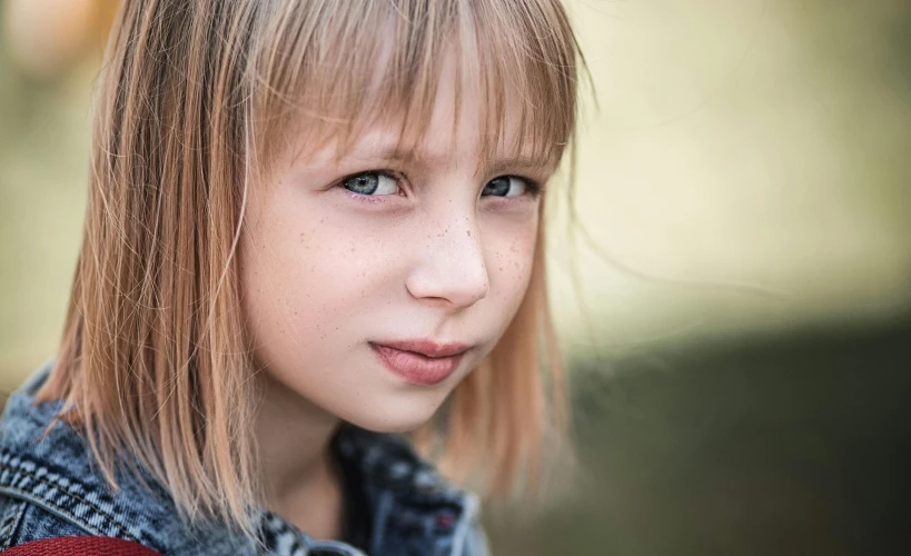 a girl with blue eyes and long hair