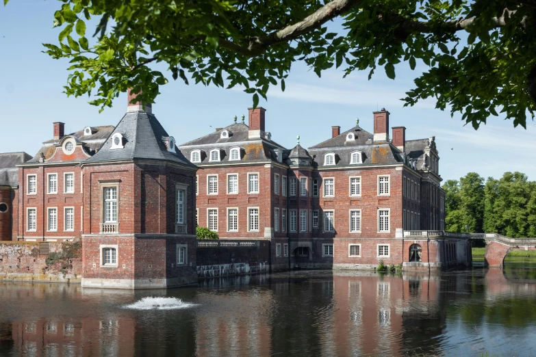 a large building with many windows and water below