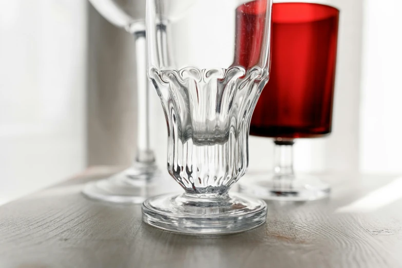 three glass vases on a wooden surface