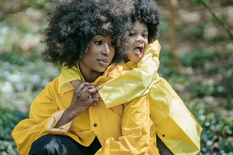 there is a woman with an afro holding a child