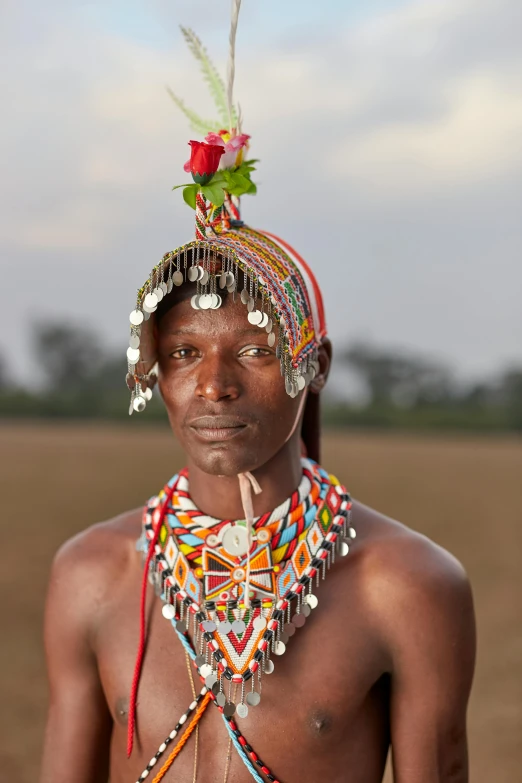 a man with an elaborately decorated head piece in a plain