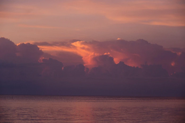 a sunset view of clouds and the ocean