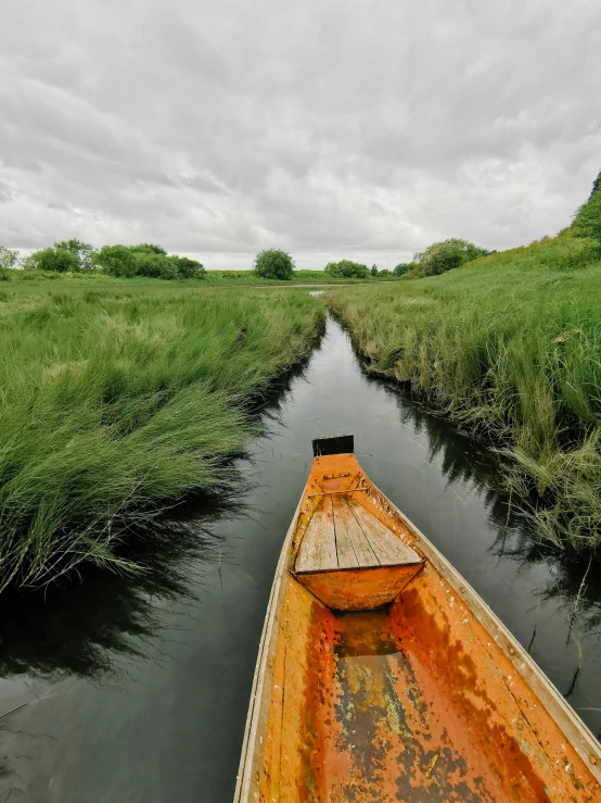 the boat is traveling down the narrow river