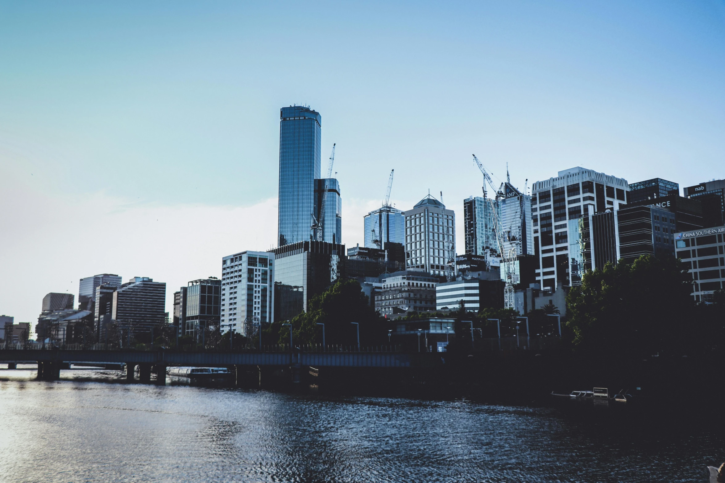 a beautiful city skyline over the water in the evening