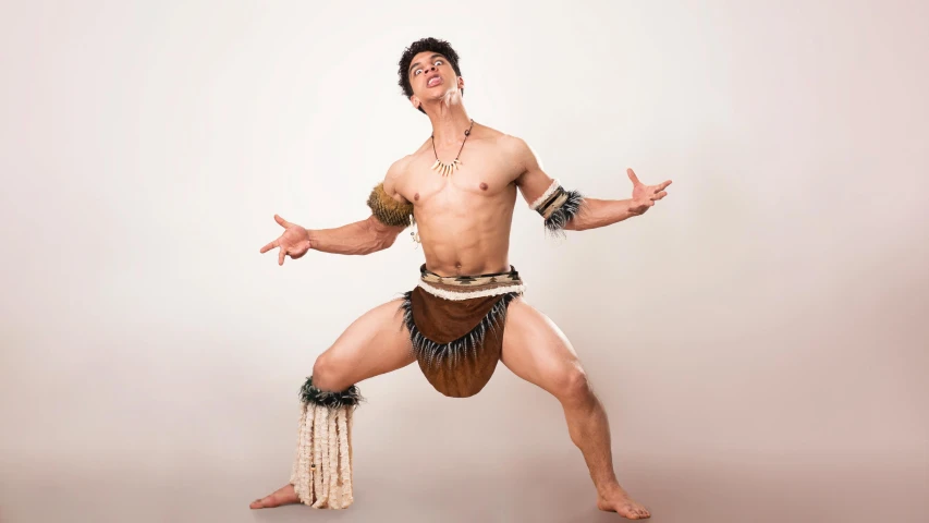 an artistic male dancer poses for a po