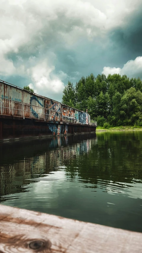 an abandoned railway train traveling along a river