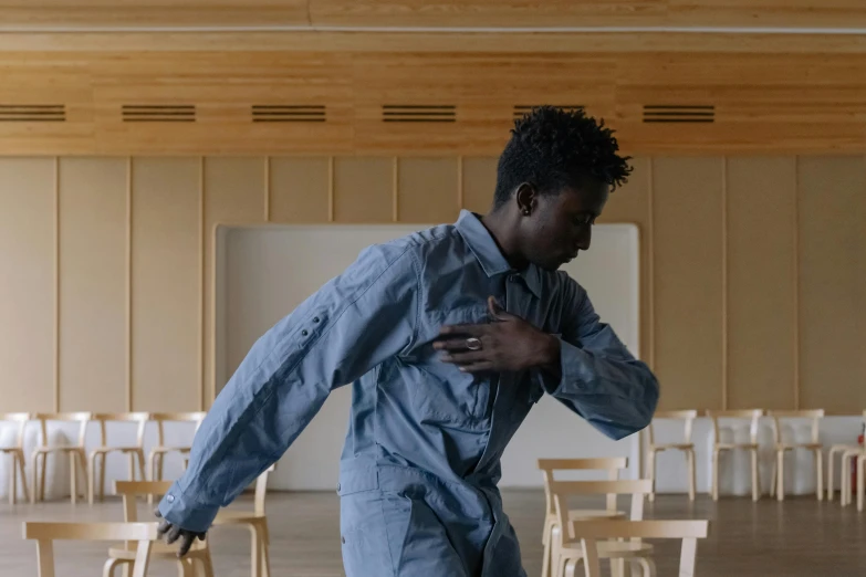 an african american man dancing in a classroom