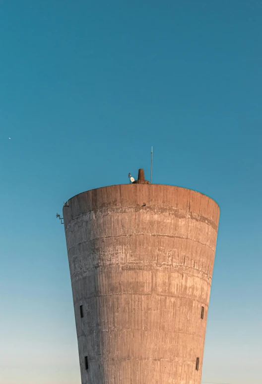 two men in a suit and tie stand at the base of a large tower