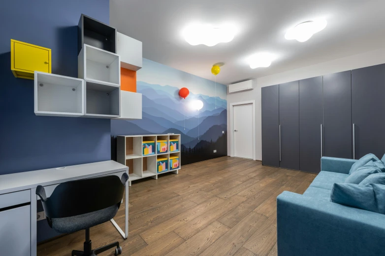 a small room with some blue couches and a large book case