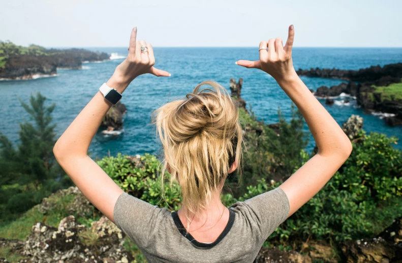 a woman has her arms in the air with both hands outstretched