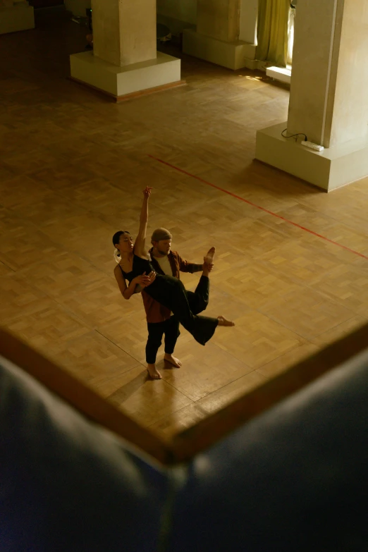two people dancing with each other in a room